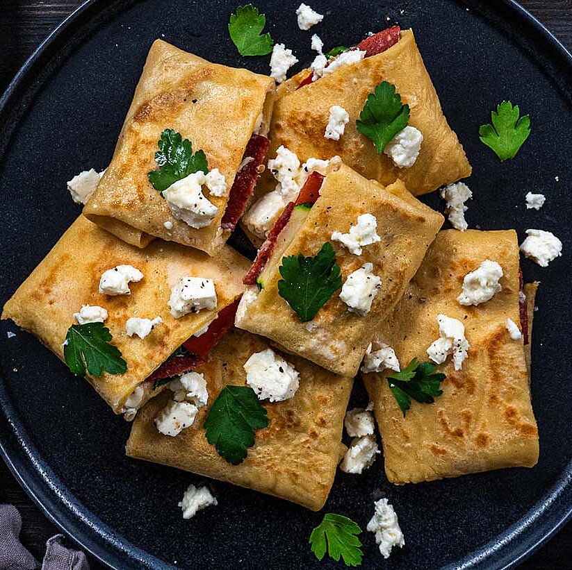 Börek pancakes filled with Ezine Lezzeti, Krem Kaymak, Sucuk sausage and vegetables